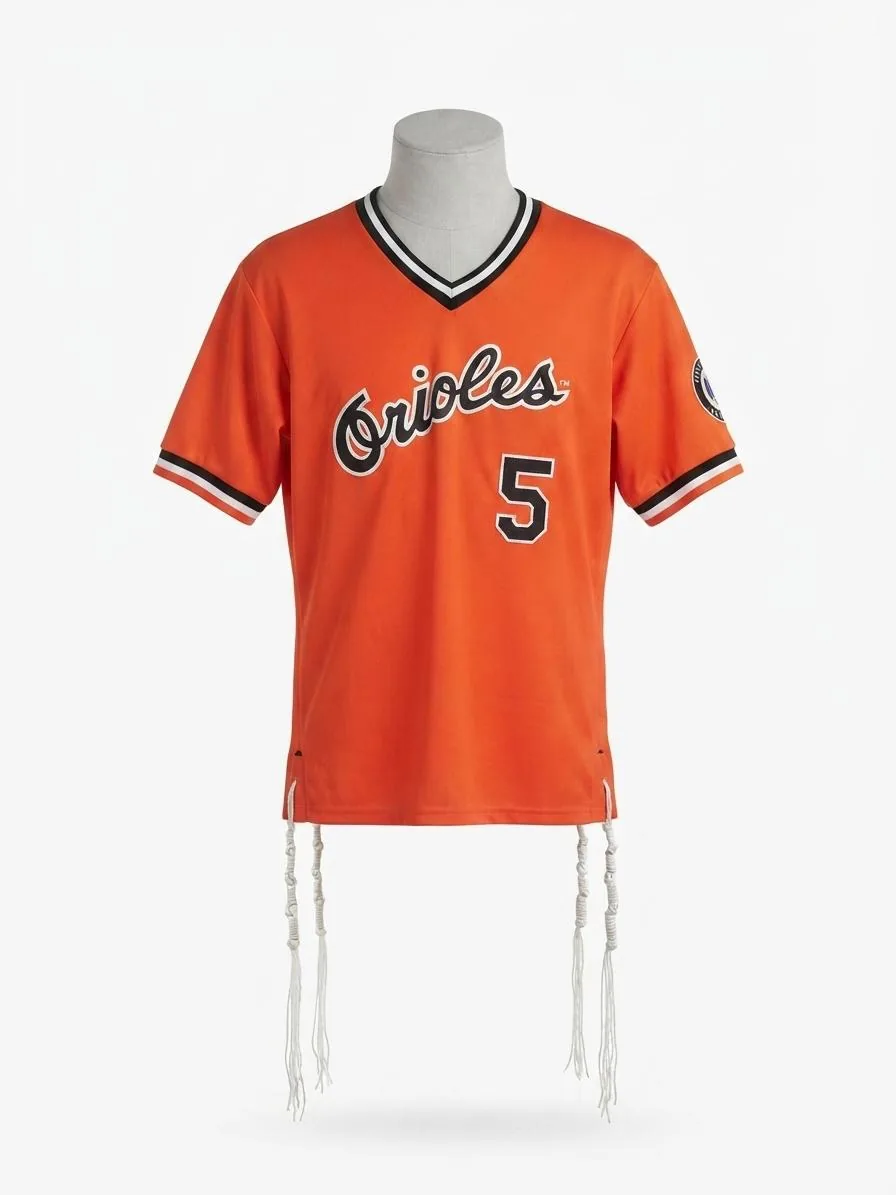 An orange baseball jersey repurposed into hand-tied tzitzit