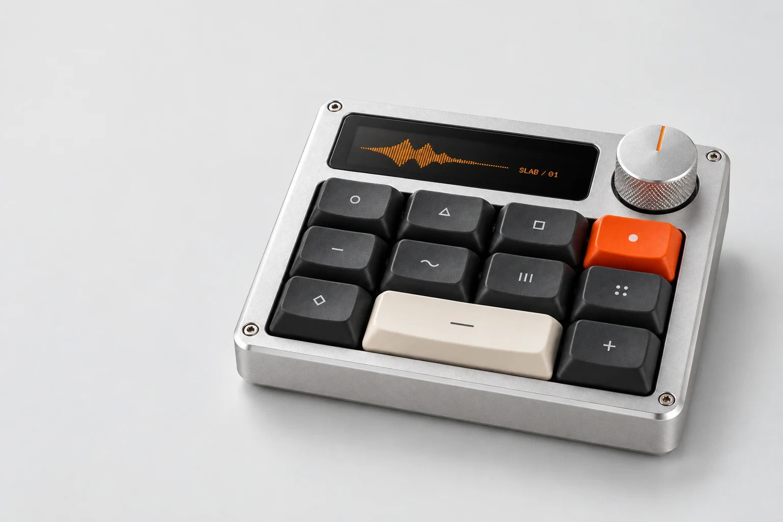 Silver SLAB controller with charcoal keys, an orange key and ivory action key